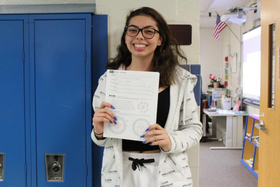Freshman Ashley Rodriguez proudly shows off her completed math homework.