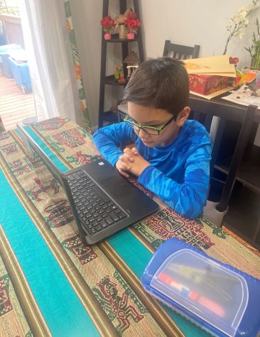 The writers brother, Marcelo Mendoza-Toledo, accesses his second grade classroom at home during distance learning.