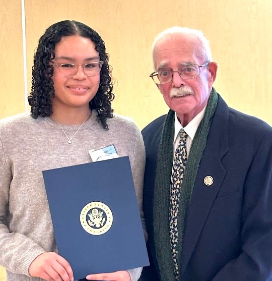 Senior Madison McLaughlin receives one of this year's twenty-eight Student Peace Awards, with her advocacy efforts honored by Rep. Gerry Connolly.