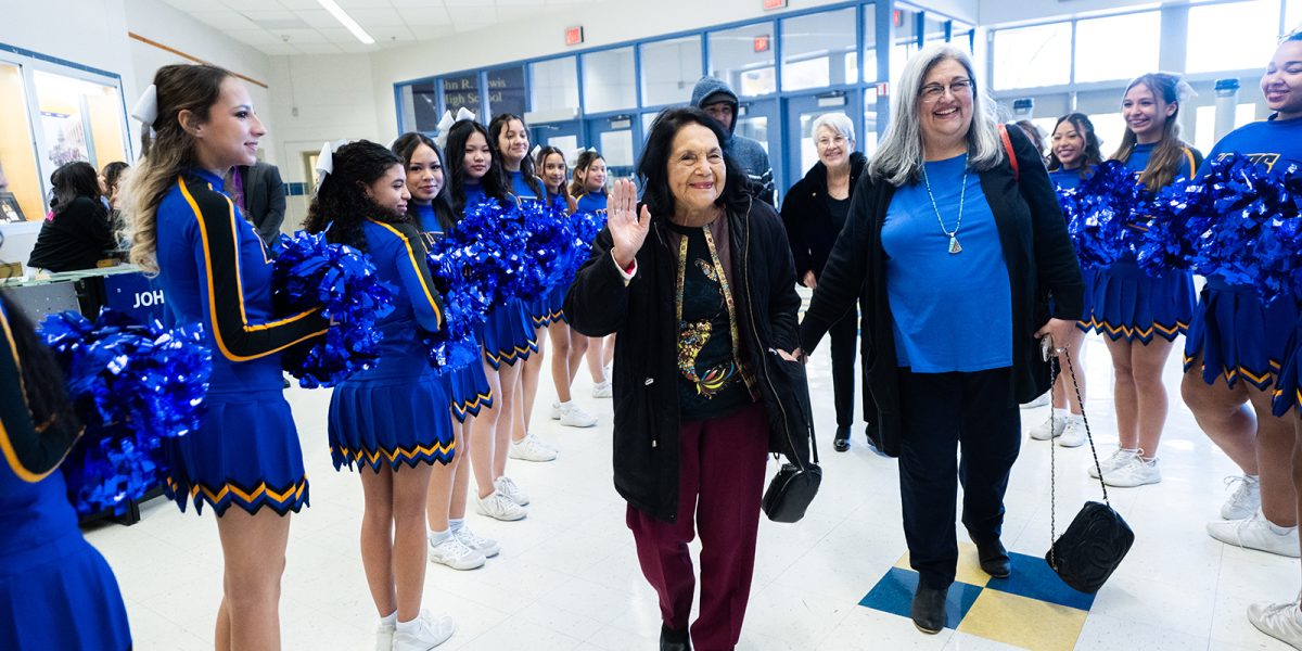 Civil Rights icon Dolores Huerta, accompanied by Franconia District School Board Representative Marcia St. John-Cunning, arrives at Lewis High School to a warm reception from Lewis' Winter Cheer Team.