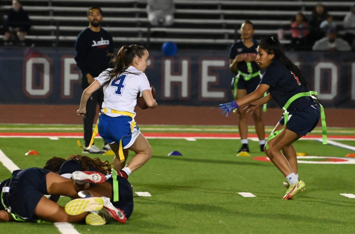 Sophomore Haylee Booth (QB) performed a successful scramble in the game between Lewis and Justice on Oct. 22.